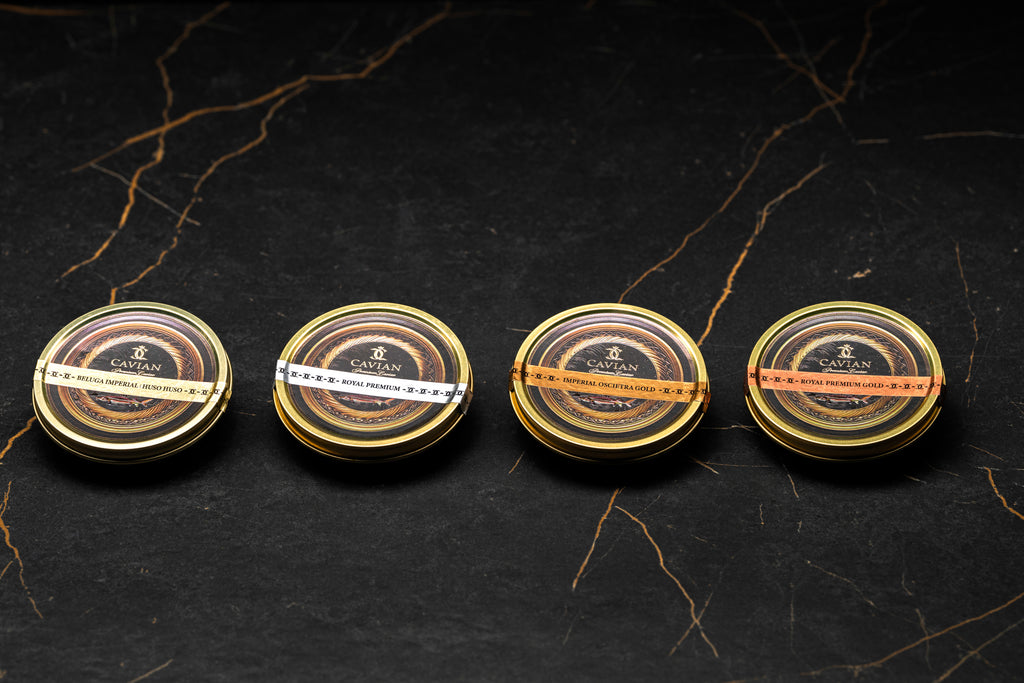 Four Cavian caviar tins featuring Beluga Imperial, Royal Premium, Imperial Oscietra Gold and Royal Premium Gold.