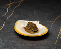 A portion of premium brown caviar pearls served on a natural iridescent mother-of-pearl shell.