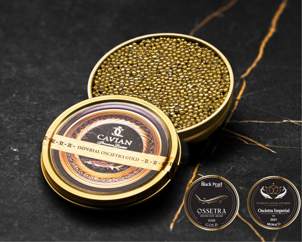 Open Cavian Imperial Oscietra Gold caviar tin with lid placed in front and award badges on a dark marble background.