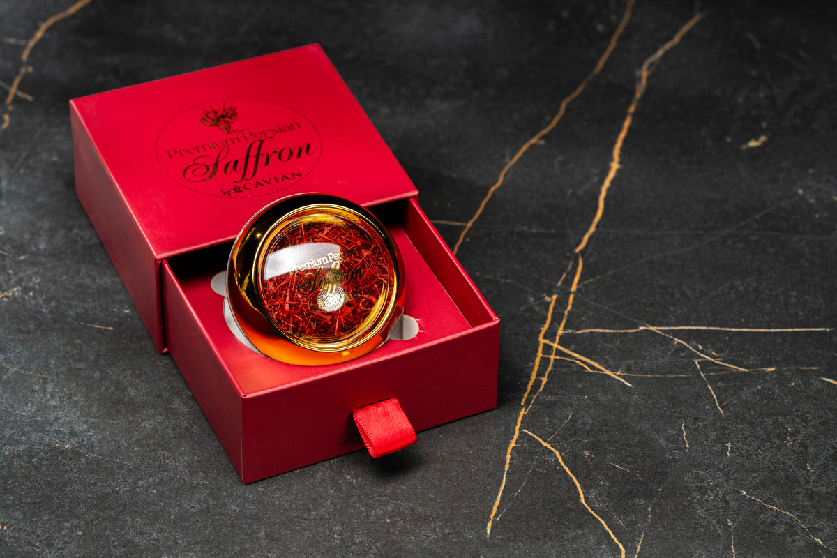 Premium Persian Saffron by Cavian in a red presentation box with an angled glass jar of saffron threads.