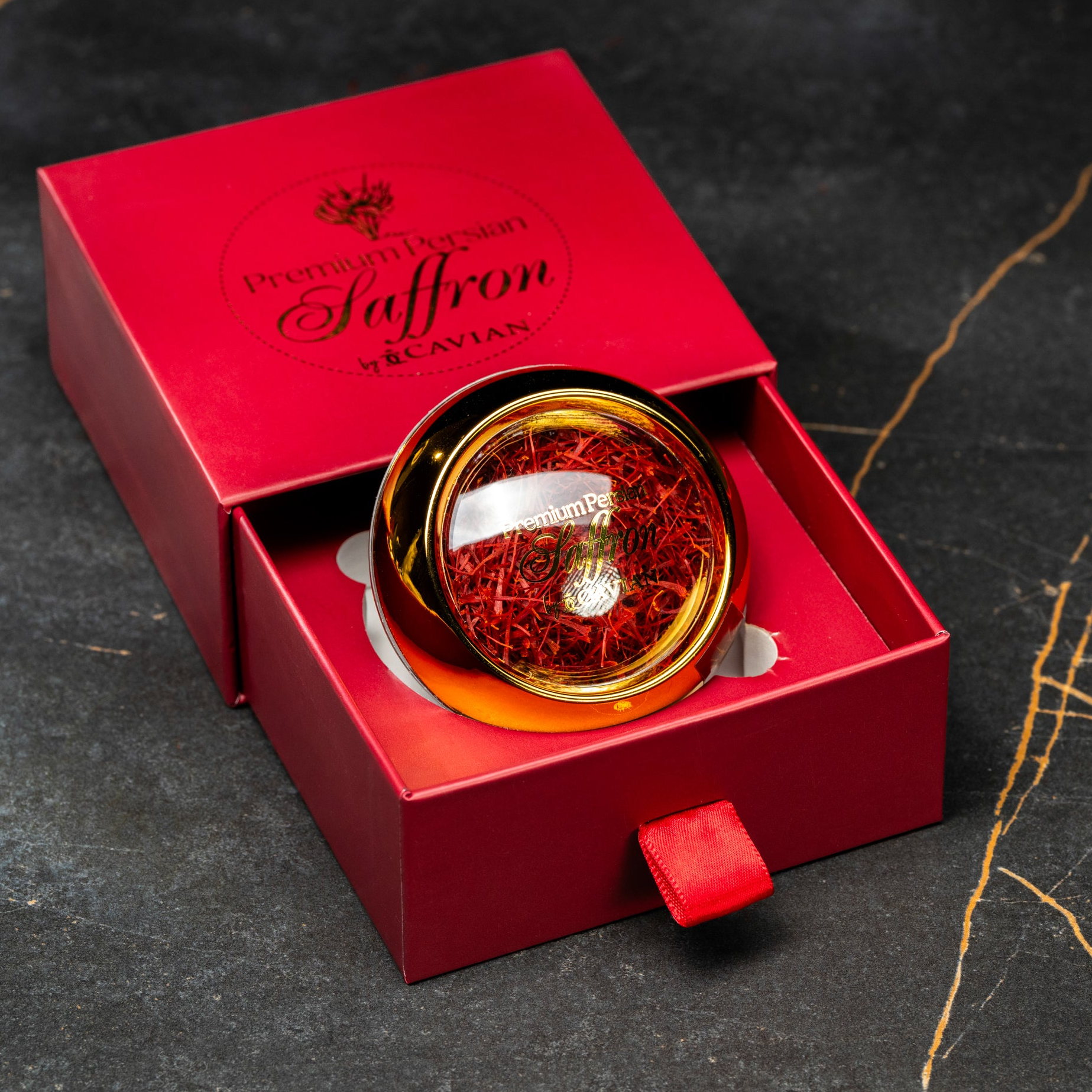 Premium Persian Saffron by Cavian in a red presentation box with an angled glass jar of saffron threads.