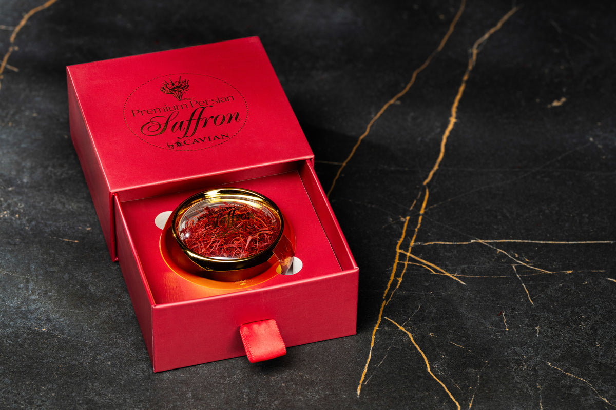 Cavian Premium Persian Saffron presented in an elegant red gift box with a glass jar of red saffron threads.