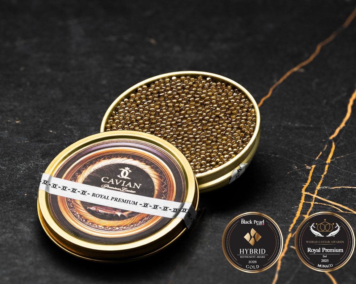 Open Cavian Royal Premium caviar tin with lid placed in front and award badges on a dark marble background.